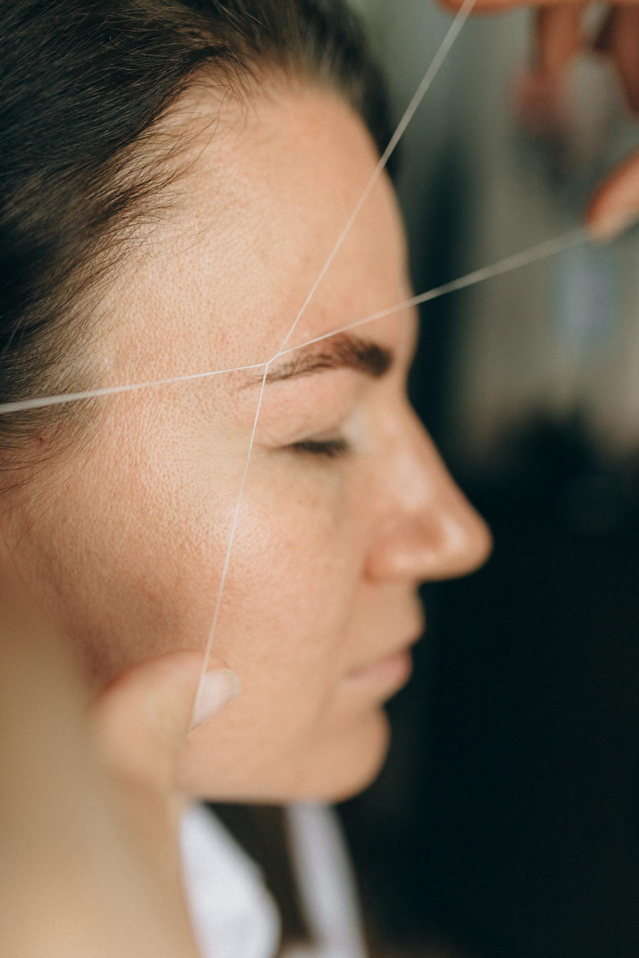 Eyebrow threading service in progress
